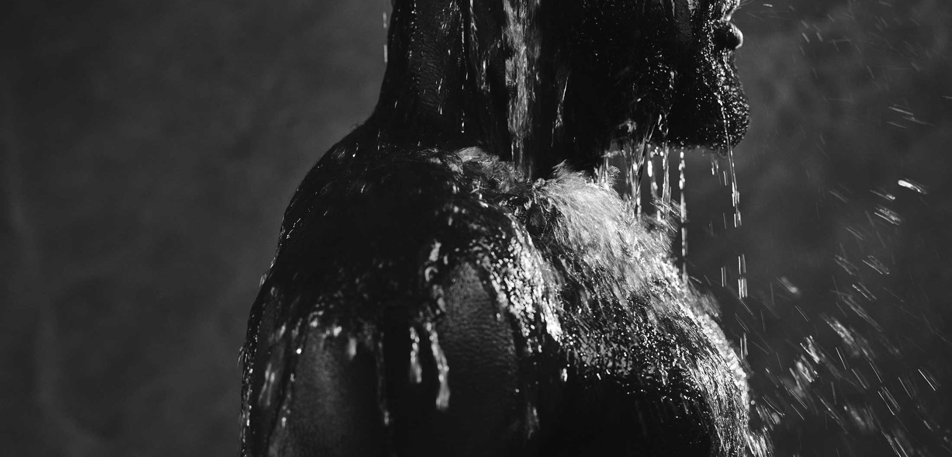 Man enjoying refreshing cold water bucket shower