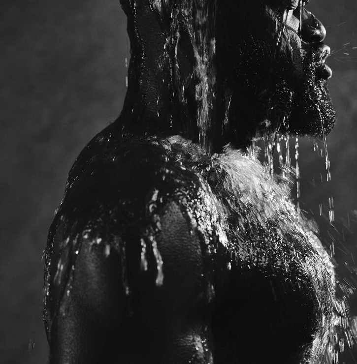 Man enjoying refreshing cold water bucket shower