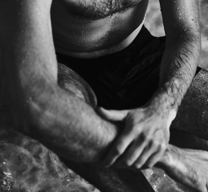 A man relaxing in the hydrotherapy pool at BASIN Glacial Waters
